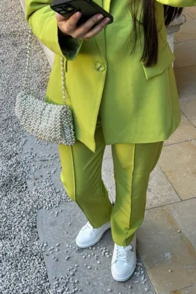 High-waisted green carrot pants.