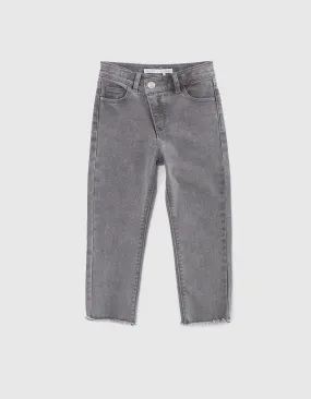 Gray girl's asymmetrical zip slim fit jeans with frayed hems.